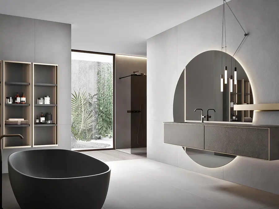 Bagno scuro con mobile sospeso e specchio tondo